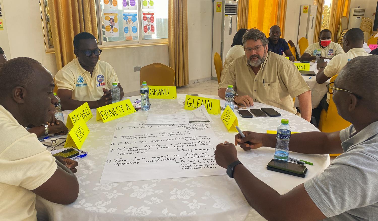Glenn Lines (second from right), Chief of Party of the Feed the Future Ghana Market Systems and Resilience Activity, engages in teambuilding exercises with staff. 
